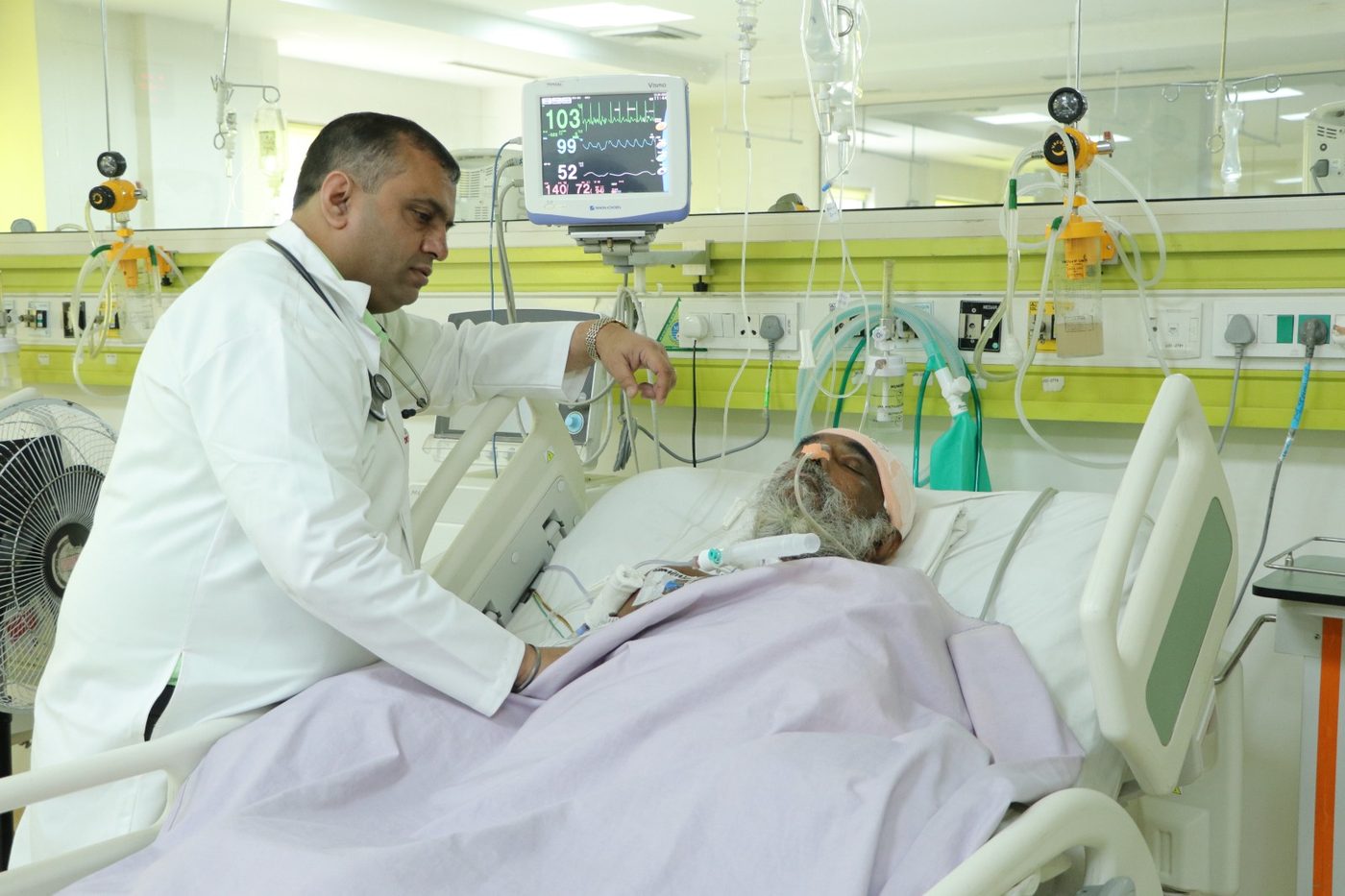Consultant reviewing a patient in critical care